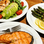 low-carb grilled salmon fillet with sautéed spinach and a side of roasted cauliflower