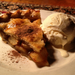 A delicious dessert plate with a slice of cake and vanilla ice cream.