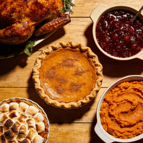 Traditional Thanksgiving pumpkin pie on a wooden table.