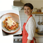 Home cook smiling in kitchen with baked pasta topped with melted cheese on penne